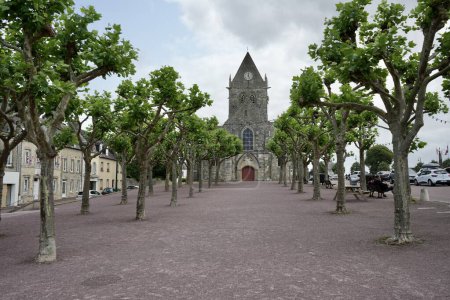 Photo for Tree lined entrance to The Church of Sainte Mere Eglise. Sainte Mere Eglise, France, July 3, 2023. - Royalty Free Image