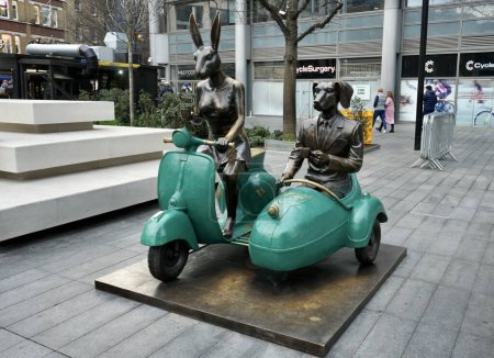 Photo for Together Forever on Wheels a sculpture by Gillie and Marc featuring  Rabbitwoman and Dogman, Vespas, and coffee. Spitalfields, London. London, UK, January 20, 2024. - Royalty Free Image