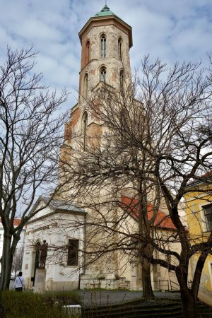 Téléchargez les photos : Église Sainte-Marie-Madeleine partiellement cachée par les arbres. Château de Buda, Budapest, Hongrie, 27 février 2024. - en image libre de droit