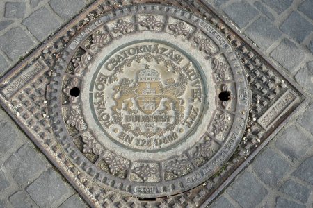 Iron Manhole Cover with Budapest decoration. Budapest, Hungary, February 27, 2024. 