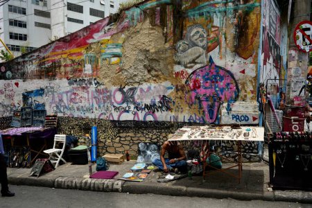 Photo for Street sellers in Lapa close to the Selaron Steps, with colourful street art behind. Rio de Janeiro, Brazil, October 27, 2023. - Royalty Free Image