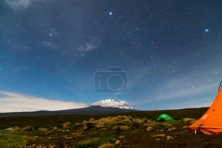 Photo for Tent pitched on gravel with Mount Kilimanjaro and stars. High quality photo - Royalty Free Image