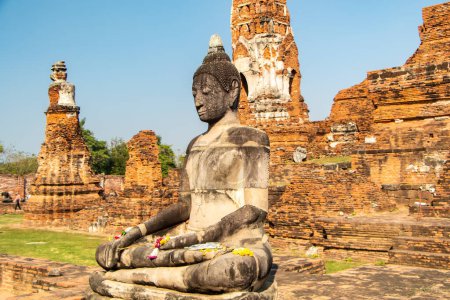 Photo for Ancient temples, Wat, Buddhist statues in Ayutthaya, Thailand. Historic red brick structures and temples. Green gras and blue sky. No people. High quality photo - Royalty Free Image