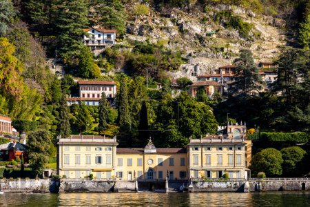 Photo for Lago di Como, Lake Como, Italy, with Palacios, grand houses, in spring. Watertaxi, Riva, typical Italian boat. Blue skies and vibrant colours. High quality photo - Royalty Free Image