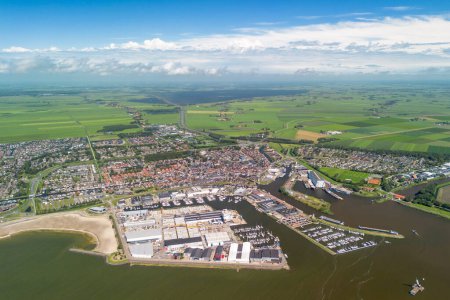 Photo for Aerial image of the city of Workum, Friesland, The Netherlands. With the harbour, marina and old village. Green meadows and Frisian lakes in the background. High quality photo - Royalty Free Image