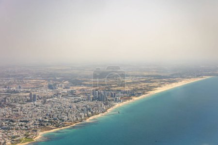 Photo for Aerial image of Israel city Tel Aviv with beach and downtown city seen from landing aircraft at Ben Gurion international airport. Coastline stretching towards war a Gaza Strip seen in distance. - Royalty Free Image