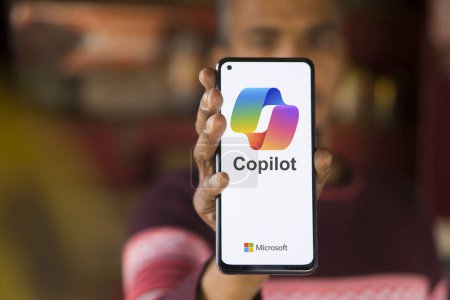 Photo for Dhaka, Bangladesh - 27 December 2023: Hand holding a phone with Microsoft Copilot AI chatbot. Microsoft Copilot is a chatbot developed by Microsoft - Royalty Free Image