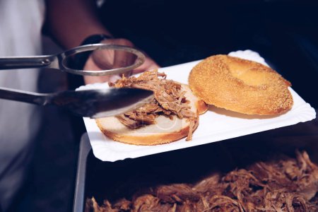 Close-up of shredded meat being served on bread