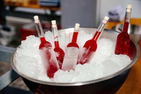 Rote hausgemachte Eis am Stiel in Eis gelagert, um gekühlt zu bleiben