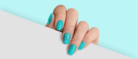 Photo for Woman's hand holding white paper. Fashionable light blue nail design - Royalty Free Image