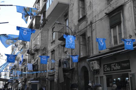 Foto de Estamos en la zona de Porta Nolana en el centro histórico de Nápoles y estas son las camisas de los jugadores de SSC Napoli suspendidos en medio de la calle durante las celebraciones por el tercer campeonato. - Imagen libre de derechos
