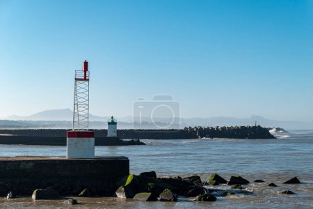 Photo for Dike on the beach of Digue in Boucau, in the Basque Country in France, with some more dikes and lighthouses in the background - Royalty Free Image