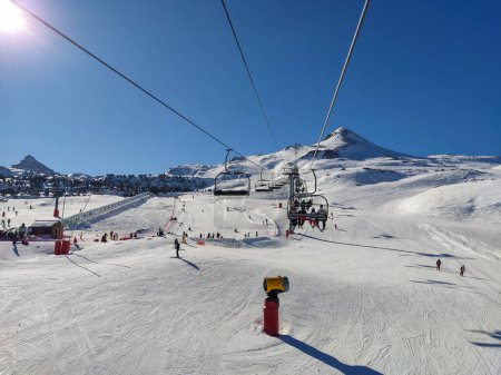 Photo for Panoramic view over a snowy piste seen from a cable car at Pierre Saint Martin in the Pyrenees, France - Royalty Free Image