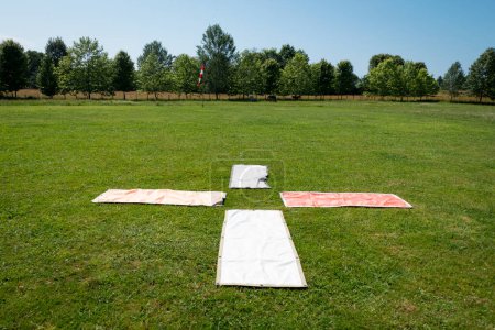 Photo for Landing indicator for skydiving in the middle of a green field, surrounded by some trees - Royalty Free Image