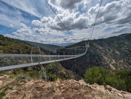 Photo for Partial view of the metal bridge suspended over the Paiva river in Arouca on a cloudy day, Portugal - Royalty Free Image