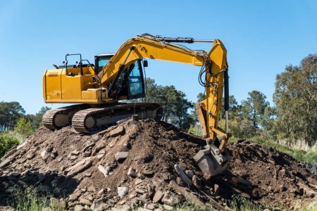 Engineering in action: The backhoe dominating the gravel pile
