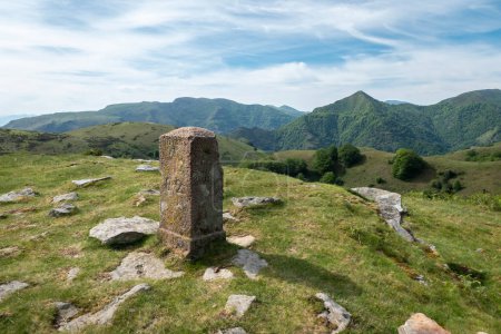 Stone marker with the description "R 82" on top of the mountain in Artzamendi in the French Basque Country