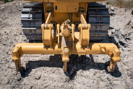 Photo for Crawler excavator with rear ripper tearing and loosening hard soil or some rock - Royalty Free Image