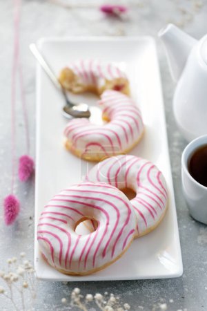 Photo for Sweet donuts with raspberries and strawberries. Tea drinking. - Royalty Free Image
