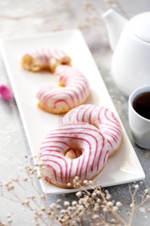 Photo for Sweet donuts with raspberries and strawberries. Tea drinking. - Royalty Free Image