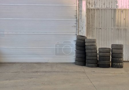 old worn tires at the door of a recycling company