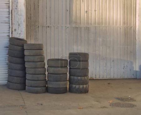 used car tires at the door of a workshop for recycling