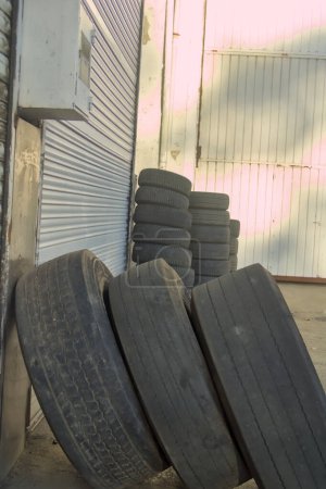 old used car and truck wheels stacked to take for recycling