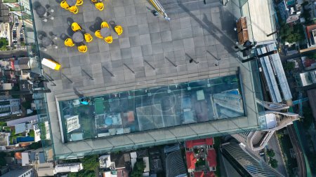 Photo for Top view of a worker cleaning the glass floor at the highest building in Bangkok. - Royalty Free Image