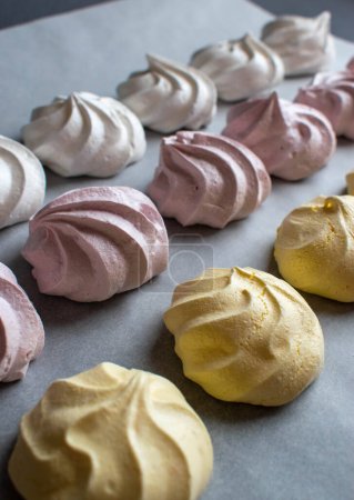 Sweet airy meringue, on a dark background. Home Cooking Concept