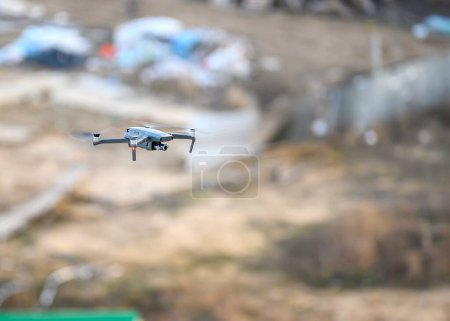 Photo for Moscow, Russia. 03-27-2020. A drone flies in the air against a background of blurry large open space. Street, the soft light of the evening sun. - Royalty Free Image
