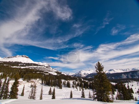snow capped mountain peaks under blue sky in colorado