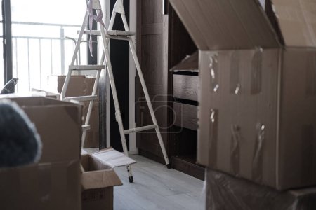 Photo for House moving, packed unpacked carton boxes, messy home - Royalty Free Image