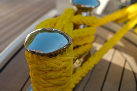 Photo for Bright yellow rope or lines tied on boat deck cleat, vessel, motor yacht , ship, sailing boat - Royalty Free Image
