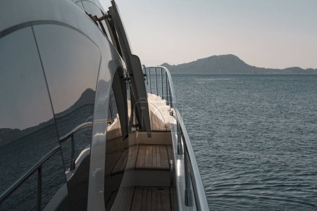 Photo for Twilight or sunset on board of motor mega yacht luxury holiday, seascape, mountain coastline, calm sea - Royalty Free Image