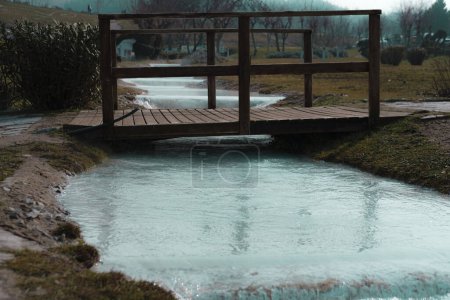 Photo for Thermal water hot springs flow under the wooden bridge - Royalty Free Image