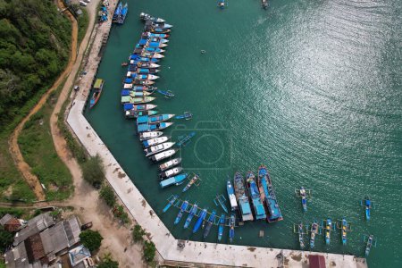 Yogya, Indonesia. November 7, 2021. blue and white fishing boats anchored in a harbor. aerial photography. Indonesia is a maritime country and the largest fish producer in the world. Indonesian harbor