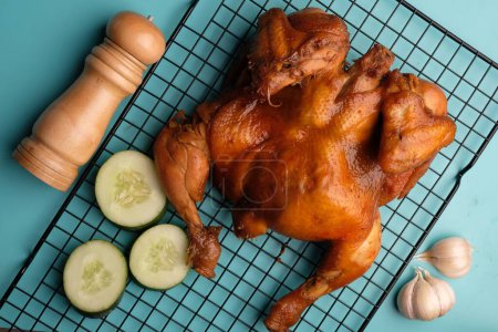 Photo for Ayam Panggang. Whole roasted chicken with soy sauce and spices. on the cooling rack. Indonesian food. - Royalty Free Image