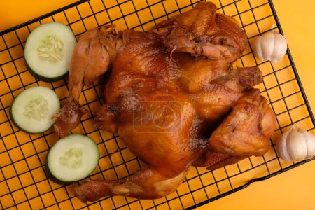Photo for Ayam Panggang. Whole roasted chicken with soy sauce and spices. on the cooling rack. Indonesian food. - Royalty Free Image