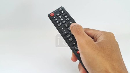 Photo for Hand holding television remote control isolated on white background - Royalty Free Image