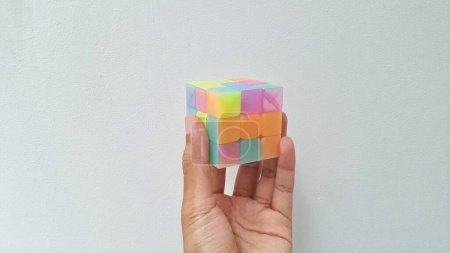 Foto de Hands holding the cube puzzle on white background. It is used to practice brain skills and competition. - Imagen libre de derechos
