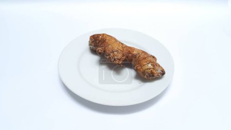 Foto de Fresh ginger on white plate isolated on white background - Imagen libre de derechos