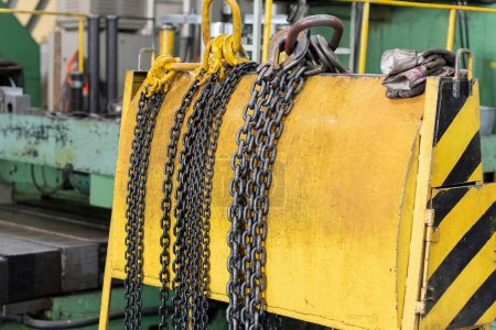 Photo for Yellow storage rack for chain slings for lifting loads on a crane. - Royalty Free Image
