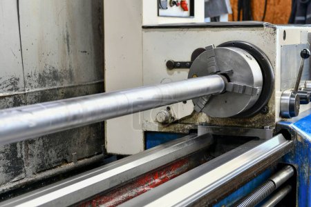 Photo for Shaft mounted in a support rest on a lathe for turning and threading. - Royalty Free Image
