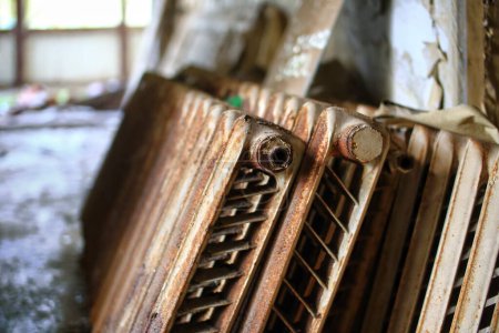 Photo for Several grungy and rusty cast iron radiators. - Royalty Free Image