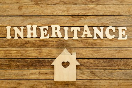 Photo for Word Inheritance made of wooden letters and house model on a wooden background, flat lay. - Royalty Free Image