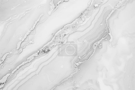 This image captures the subtle elegance of white marble, with flowing lines of silver creating a serene, river-like pattern. It exudes a minimalist charm, perfect for a contemporary space that values purity and a monochromatic palette, while the hint
