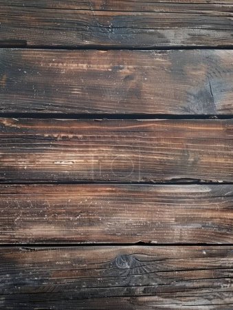 This image captures the raw and rustic beauty of dark charred wooden planks, each bearing the marks of wear and tear.