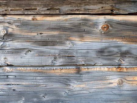 This image features aged grey wooden planks, highlighting the rich texture and natural imperfections from weather exposure.