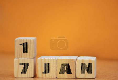Photo for Cube shape calendar for January 17 on wooden surface with empty space for text, new year Wooden calendar with date, January cube calendar on wooden surface with copy space. - Royalty Free Image