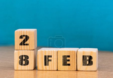 Foto de Cube shape calendar for February 28 on wooden surface with empty space for text,cube calendar for december on wood background - Imagen libre de derechos